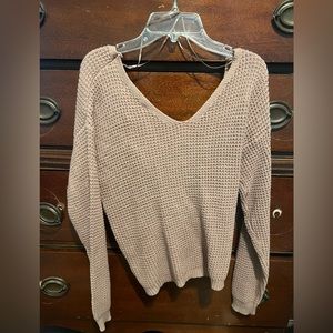 Cute sweater with a little fun in the back. Never been worn!